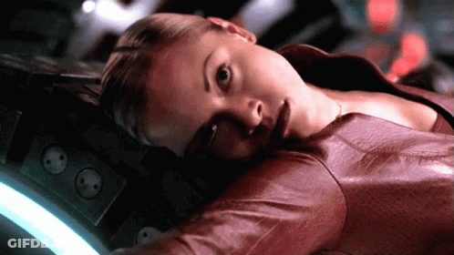 A Woman In A Red Leather Jacket Laying Down GIF