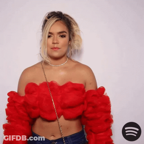 A Woman In A Red Off The Shoulder Top GIF