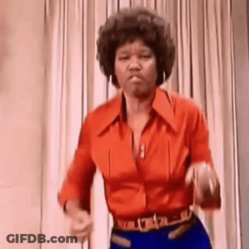 A Woman In A Red Shirt And Blue Jeans Is Dancing . GIF