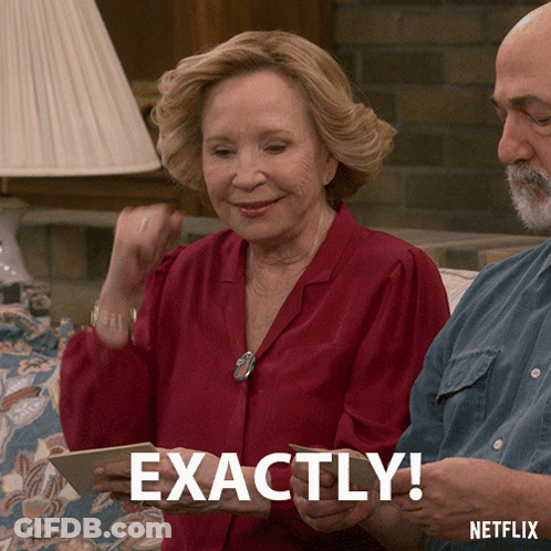 A Woman In A Red Shirt Is Holding A Card That Says Exactly GIF