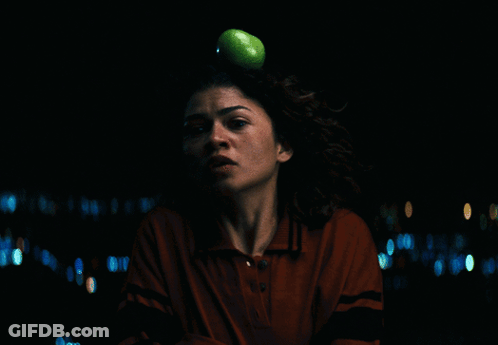 A Woman In A Red Shirt Is Looking At The Camera GIF