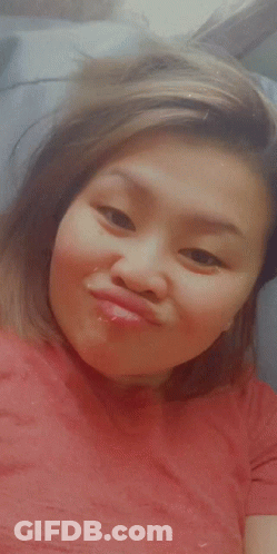 A Woman In A Red Shirt Is Making A Face GIF