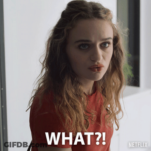 A Woman In A Red Shirt Is Making A Funny Face With The Words What Written Below Her GIF