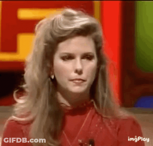 A Woman In A Red Shirt Is Sitting In Front Of A Red Sign . GIF