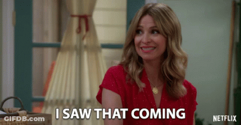 A Woman In A Red Shirt Is Smiling And Says I Saw That Coming GIF