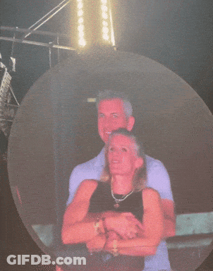 A Woman In A Red Shirt Is Standing In Front Of A Large Circle GIF
