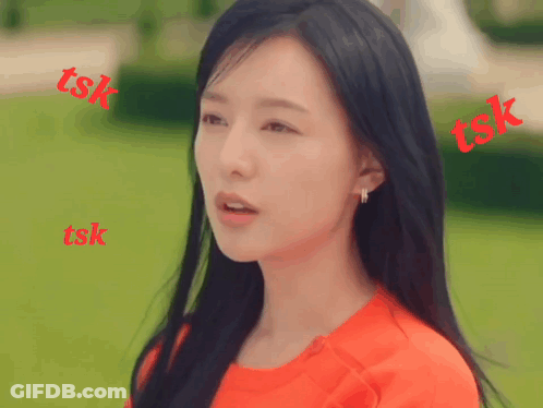 A Woman In A Red Shirt Is Surrounded By Red Tsk Letters GIF