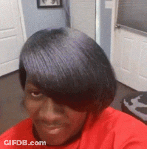 A Woman In A Red Shirt Is Taking A Selfie With Her Hair . GIF