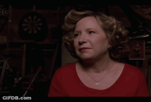 A Woman In A Red Shirt Says Trademicros In Yellow Letters GIF