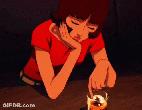 A Woman In A Red Shirt Sits At A Table With A Glass Of Whiskey In Front Of Her GIF