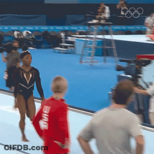 A Woman In A Red Shirt That Says ' Smith ' On The Back Of It GIF