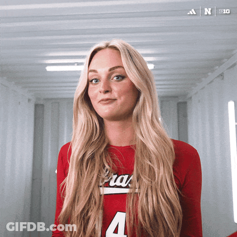 A Woman In A Red Shirt With The Number 4 On The Front GIF