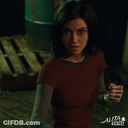 A Woman In A Red Shirt With The Word Alita At The Top GIF