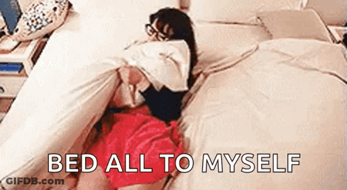 A Woman In A Red Skirt Is Laying On A Bed With The Words `` Bed All To Myself '' Above Her . GIF