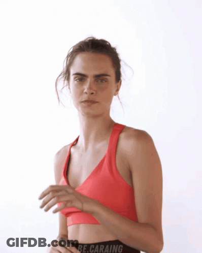 A Woman In A Red Sports Bra With The Word Be.caraing On The Bottom GIF