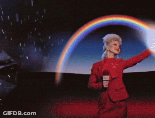 A Woman In A Red Suit Is Holding A Microphone And A Rainbow Is Behind Her GIF
