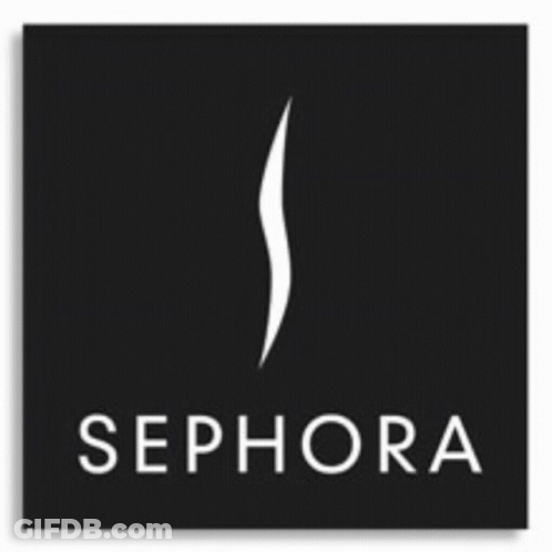 A Woman In A Red Suit Is Standing In Front Of The Sephora Logo GIF