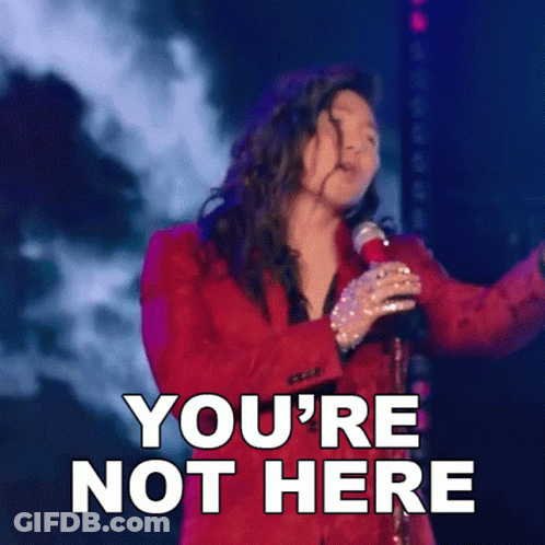 A Woman In A Red Suit Singing Into A Microphone With The Words You 'Re Not Here Above Her GIF