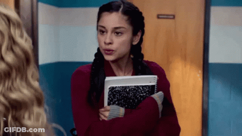Woman In Red Sweater Holding Notebook GIF