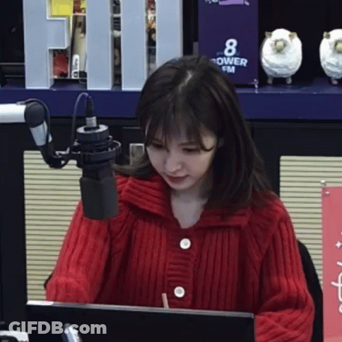 Woman In Red Sweater Sitting At Microphone GIF