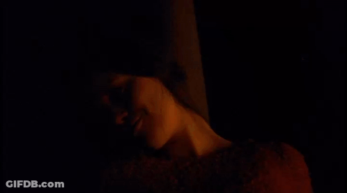 A Woman In A Red Sweater Is Smiling With The Words Digging Holes For Posts Below Her GIF
