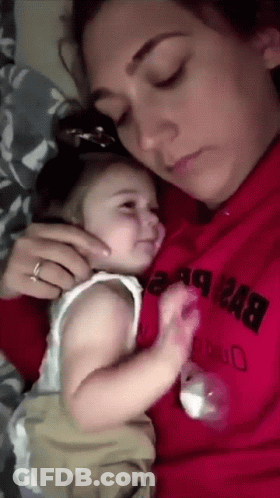 A Woman In A Red Sweatshirt Holds A Baby GIF