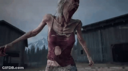 A Woman In A Red Tank Top Is Standing In Front Of A Barn . GIF