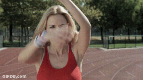 A Woman In A Red Tank Top Is Throwing A Basketball GIF