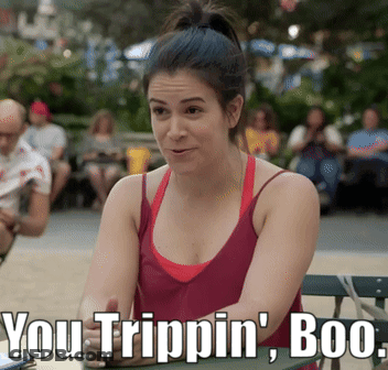 A Woman In A Red Tank Top Sits At A Table With The Words You Trippin ' Boo Written Below Her GIF