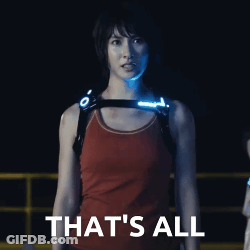 A Woman In A Red Tank Top Stands In Front Of A Sign That Says " That 'S All " GIF