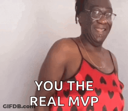 A Woman In A Red Tank Top With Hearts On It Is Smiling And Says `` You The Real Mvp '' . GIF