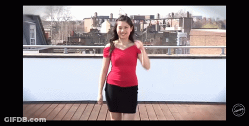 Woman In Red Top And Black Skirt On Balcony GIF