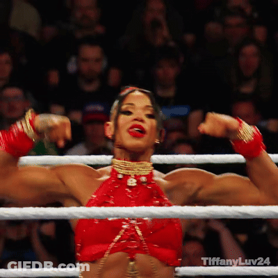 A Woman In A Red Top Flexes Her Muscles In A Boxing Ring With Tiffanyluv24 Written On The Bottom GIF