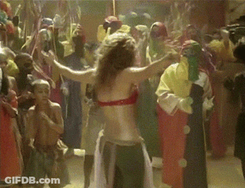 A Woman In A Red Top Is Dancing In A Crowd GIF