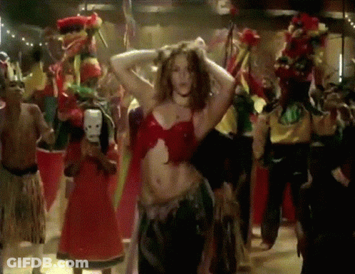 A Woman In A Red Top Is Dancing With A Group Of People GIF