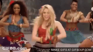 A Woman In A Red Top Is Dancing With A Group Of Women . GIF