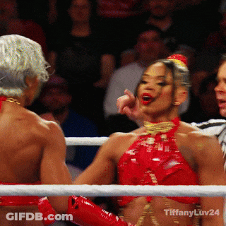A Woman In A Red Top Is Standing In A Boxing Ring With Tiffany Luv24 Written On The Bottom GIF