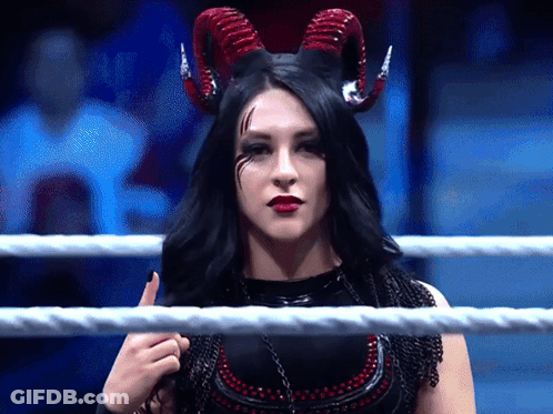A Woman In A Ring With Horns On Her Head GIF