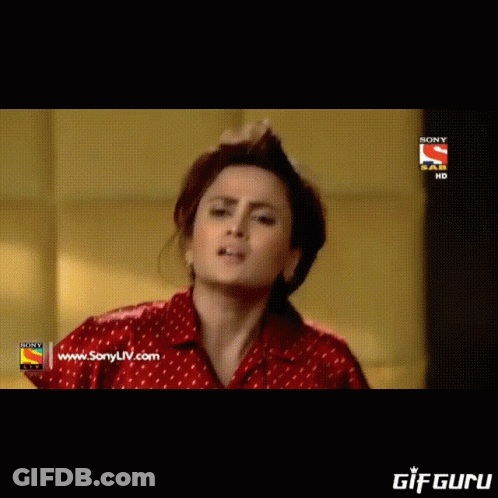 A Woman In A Saree Is Standing In Front Of A Sign That Says Sony Hd GIF