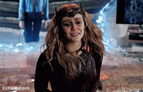A Woman In A Scarlet Witch Costume Is Crying With Tears Running Down Her Face GIF