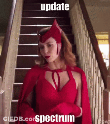 A Woman In A Scarlet Witch Costume Is Standing On Stairs GIF