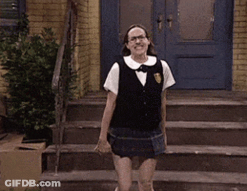 A Woman In A School Uniform Is Dancing On The Stairs GIF