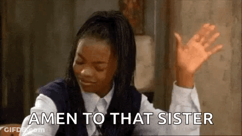A Woman In A School Uniform Is Sitting At A Table With Her Hands In The Air And Says Amen To That Sister . GIF