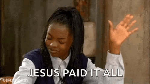 A Woman In A School Uniform Is Sitting At A Table With Her Hands In The Air And Says `` Jesus Paid It All '' . GIF