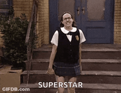 A Woman In A School Uniform Is Standing On A Set Of Stairs In Front Of A Blue Door . GIF