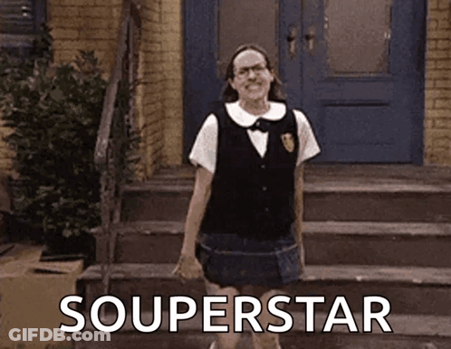 A Woman In A School Uniform Is Standing On A Set Of Stairs In Front Of A Door . GIF