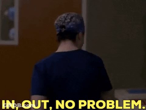 A Woman In A Scrub Top Is Standing In Front Of A Door And Says In Out No Problem GIF