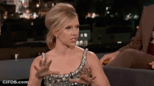 A Woman In A Sequined Dress Is Making A Funny Face GIF