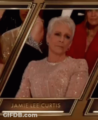 A Woman In A Sequined Dress Is Sitting In A Row Of Frames At An Event . GIF