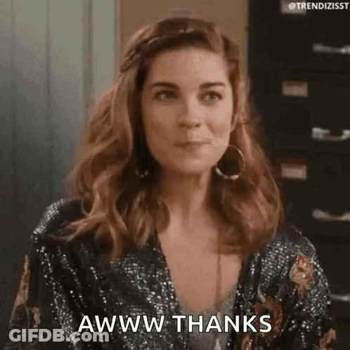 A Woman In A Sequined Jacket Is Making A Funny Face And Saying Awww Thanks . GIF